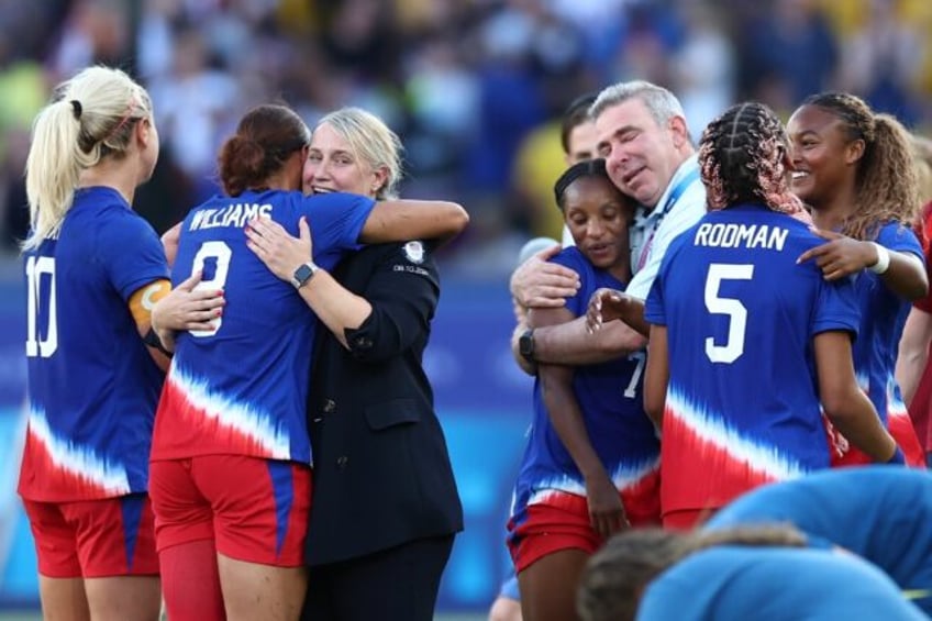 United States women's football coach Emma Hayes (3L) celebrates with the team after winnin