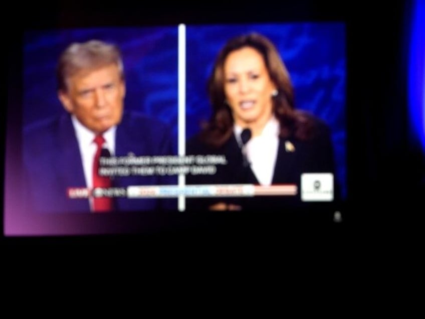 A man watches the presidential debate between Republican presidential nominee former Presi