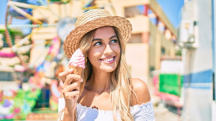 Woman eating at amusement park