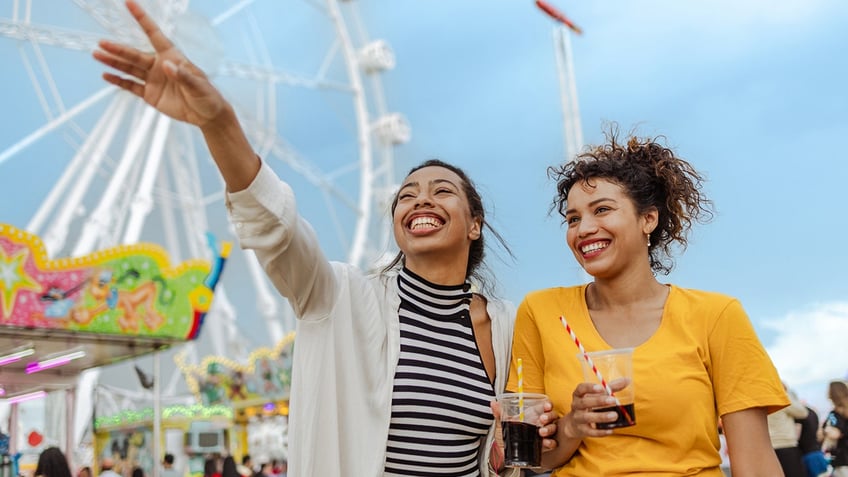 Amusement park guests drinking tea