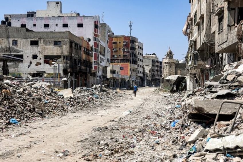 A man walks past rubble along a street in the Tuffah district in the east of Gaza City on