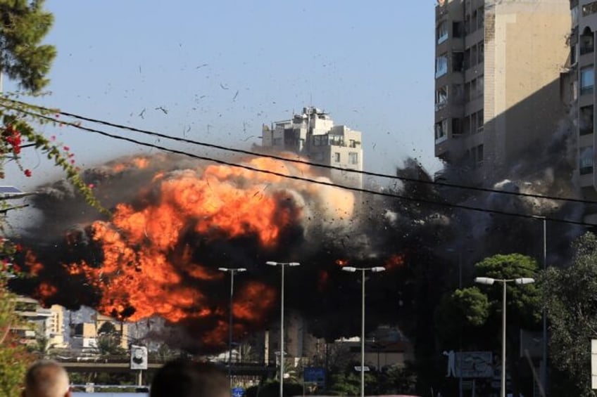 A ball of fire erupts as an Israeli strike hits a building in the Beirut southern suburb o