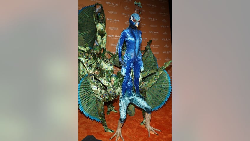 heidi klum dresses up as a giant peacock for halloween after teasing with stripped down photo