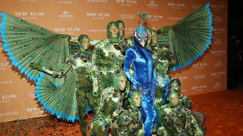 heidi klum dresses up as a giant peacock for halloween after teasing with stripped down photo