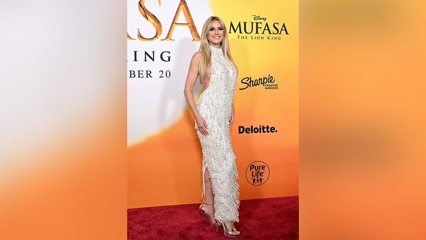 Heidi Klum wore a shiny beaded white gown with fringe to the premiere of "Mufasa: The Lion King."