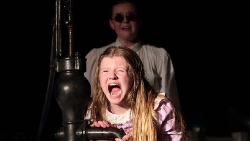Lillie Meyer stars as Helen Keller in a scene from "The Miracle Worker" performed on the grounds at Ivy Green, Keller's birthplace, in Tuscumbia, Alabama.