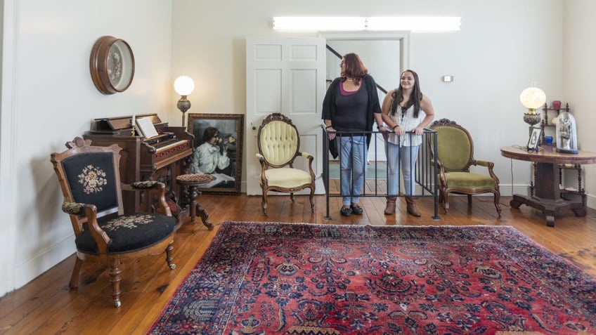 Visitors take a look inside Ivy Green, Helen Keller's birthplace in Tuscumbia, Alabama.
