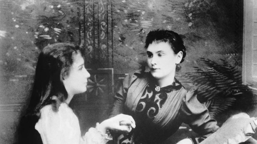 Hellen Keller is shown, age 13, with teacher Anne Sullivan in 1893.