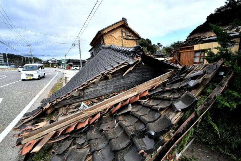 The earthquake left deep cracks in concrete and brought down entire wooden homes so only their tiled roofs lay on the ground