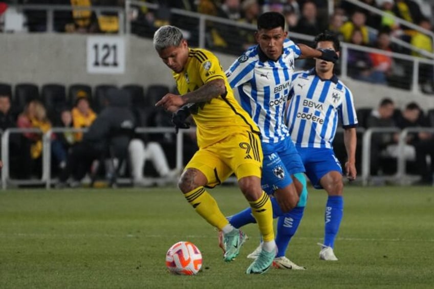 Columbus forward Cucho Hernandez dribbles past Monterrey's Jesus Gallardo in their CONCAC