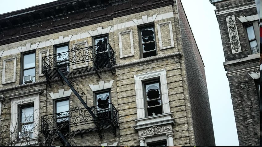 Several blown out windows on a six-story building