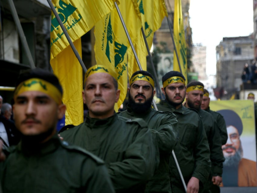 FILED - 01 March 2020, Lebanon, Beirut: Pro-Iranian Hezbollah militants hold flags during the funeral procession of five of their colleagues who were killed in clashes with Turkish army in the Syrian province of Idlib. At least 14 fighters of Lebanon's Shiite Hezbollah militia, including one Iranian, killed in an attack by Turkish drones in the countryside of Idlib and Aleppo on Saturday, a monitoring group says. Photo: Marwan Naamani/dpa (Photo by Marwan Naamani/picture alliance via Getty Images)