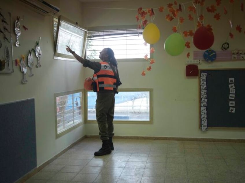 An Israeli soldier from the Homefront Command unit inspects the site where a drone launche