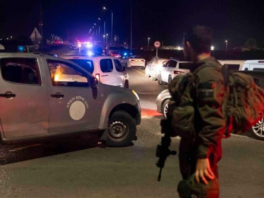 BINYAMINA, ISRAEL - OCTOBER 13: An Israeli soldier secures a road after a drone attack tha