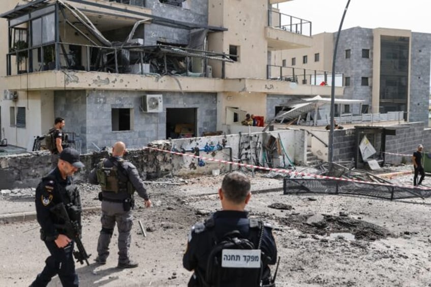 Isreli security forces inspect the area of the border town of Kiryat Shmona where a suspec