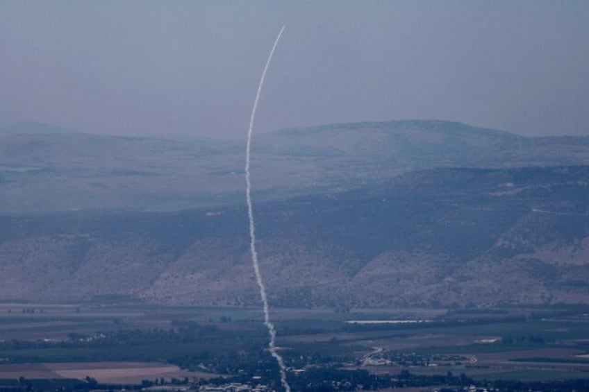 A rocket fired from southern Lebanon is intercepted by Israel's Iron Dome air defence syst