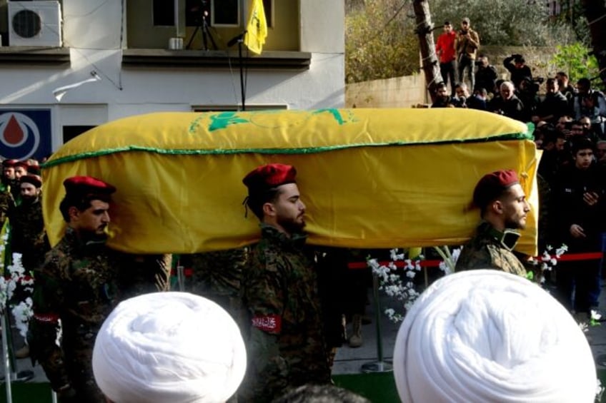 Hezbollah militants carry the coffin of Wissam Tawil during his funeral in Khirbit Silm