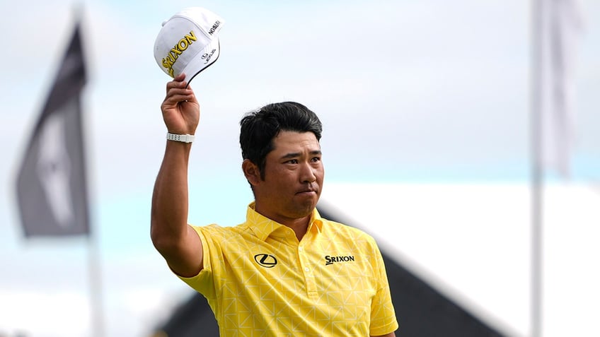 Hideki Matsuyama raises hat