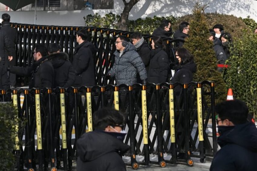 Anti-corruption investigators leave the residence of South Korea's impeached President Yoo