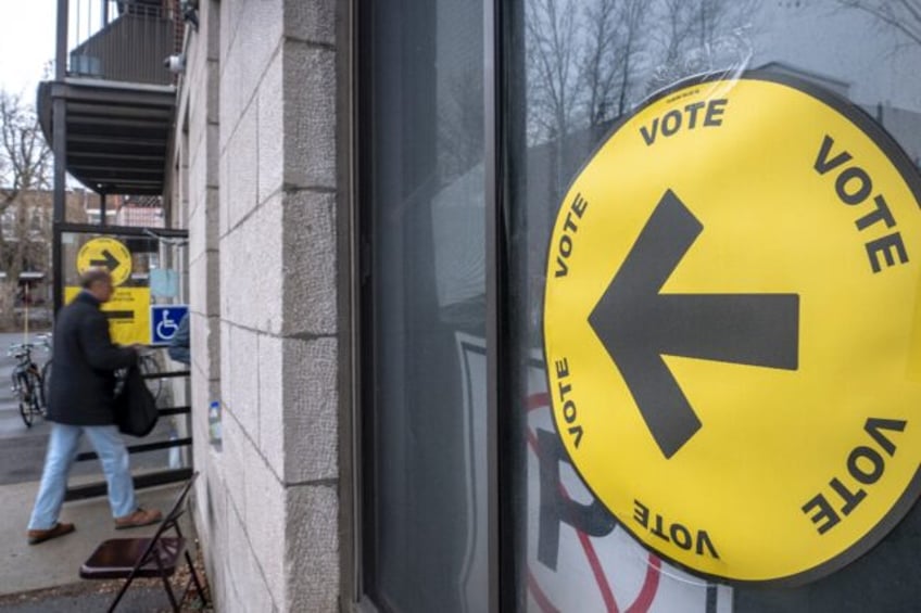 A man enters a polling location during early voting in Montreal, Canada, on April 19, 2025