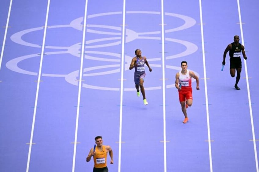 Sixteen-year-old Quincy Wilson (2nd from L) helped the United States into the Olympic 4x40