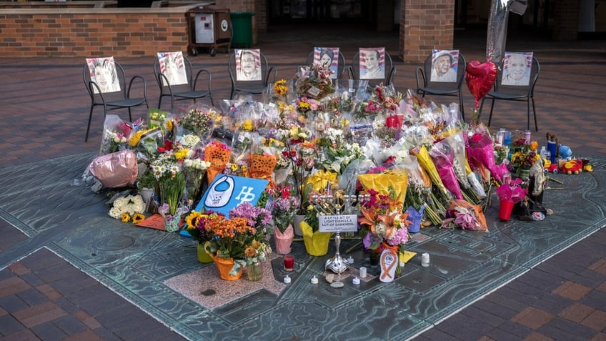 A make-shift memorial has sprung in the city center near where police say accused shooter Robert 