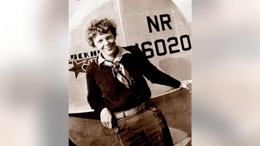 Amelia Earhart in front of plane