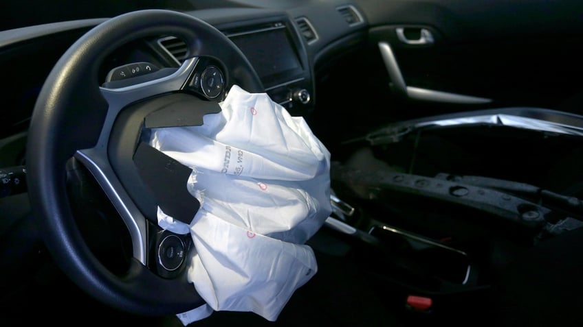 The deflated airbag of a 2015 Honda Civic is seen.