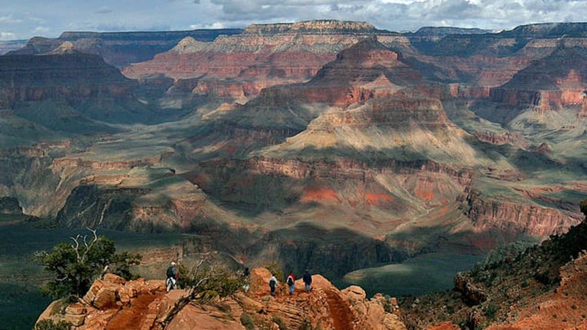 With the North Rim in the background, tourists hike along the South Rim of the Grand Canyon Tuesday, Feb. 22, 2005.