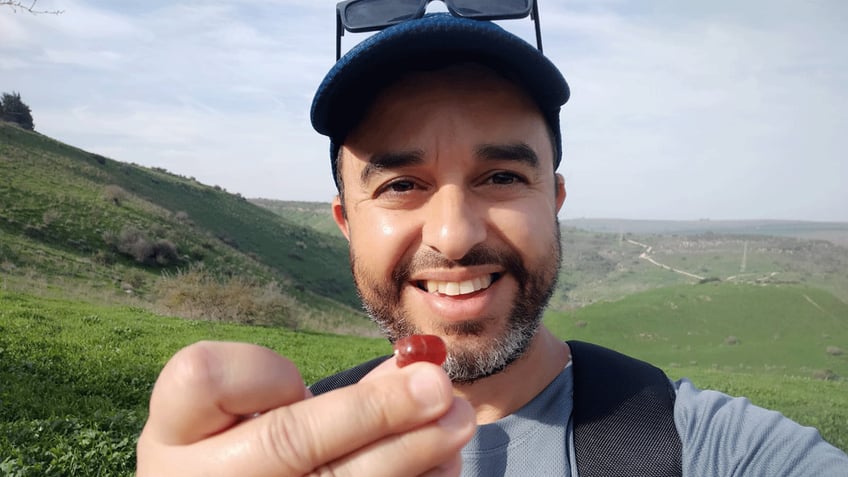 . Erez Abrahamov holding scarab seal