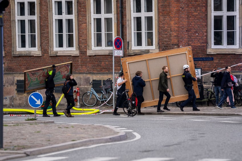 historic artworks rushed into streets as one of copenhagens oldest buildings burns