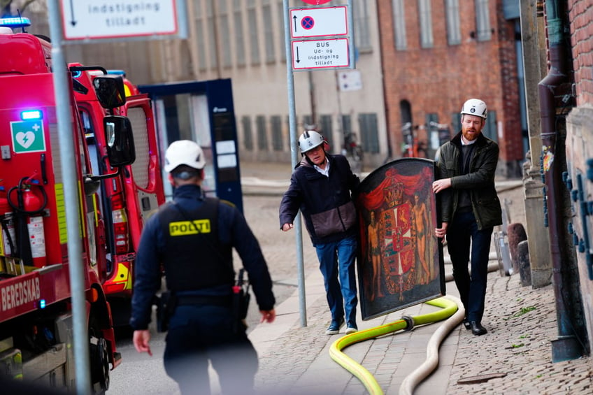 historic artworks rushed into streets as one of copenhagens oldest buildings burns