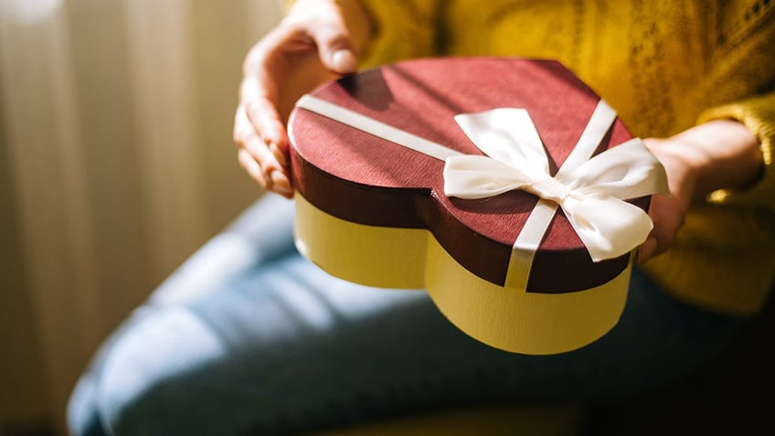 woman holding valentine's day box