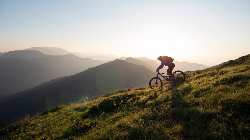 Person riding a bike on the mountain.