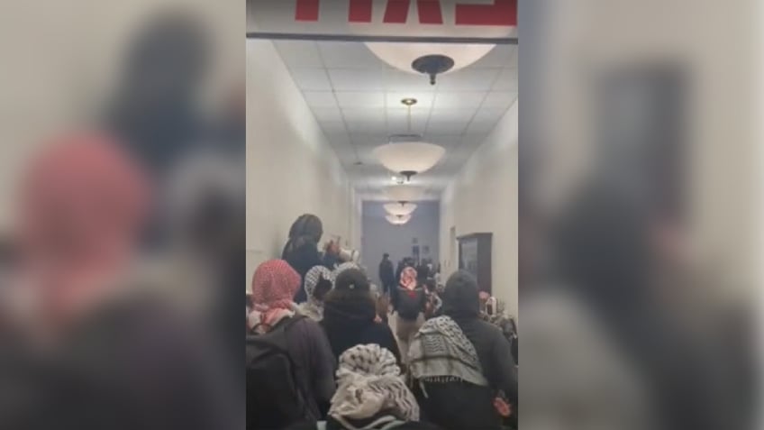 group of protesters inside hallway