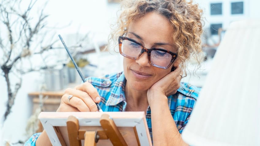 An artist painting on canvas