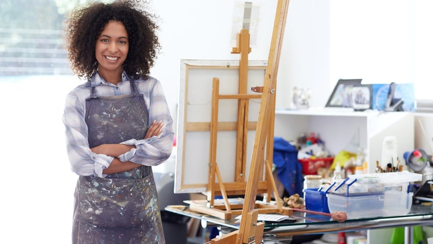 Woman wearing an apron while painting