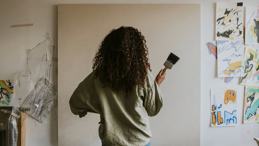 Artist looking at a blank canvas