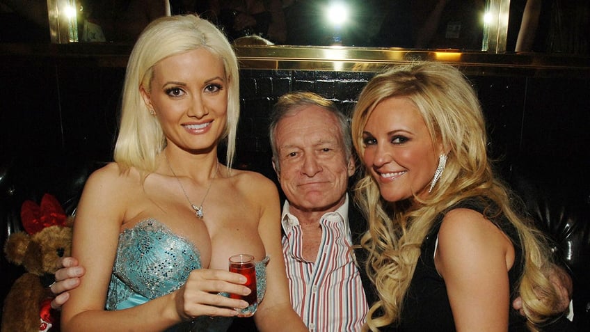 Holly Madison, Hugh Hefner and Bridget Marquardt posing and smiling with each other