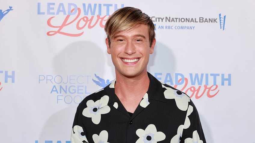 Tyler Henry smiling on the red carpet