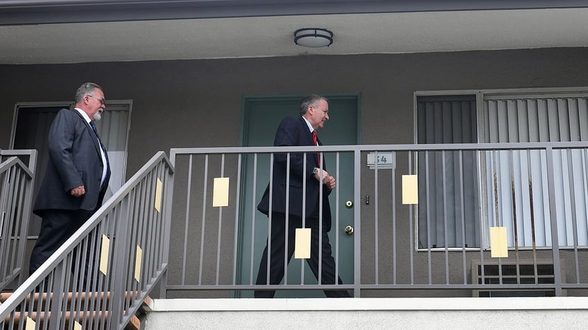 Detectives walking pasting Michael Gargiulos home