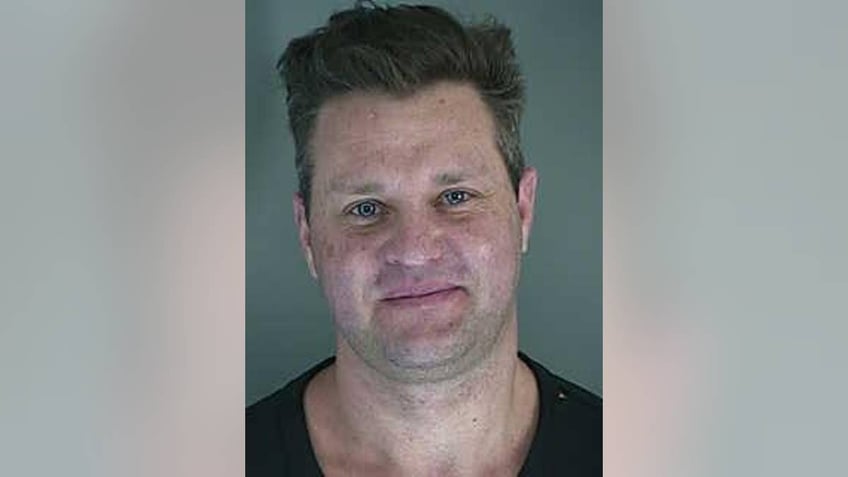 Zachery Ty Bryan soft smiles in mugshot