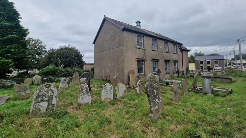 home in the middle of a cemetery is up for sale ahead of the spooky halloween holiday see the photos