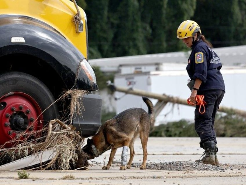 A member of the FEMA Urban Search and Rescue Task Force searches a flood damaged business