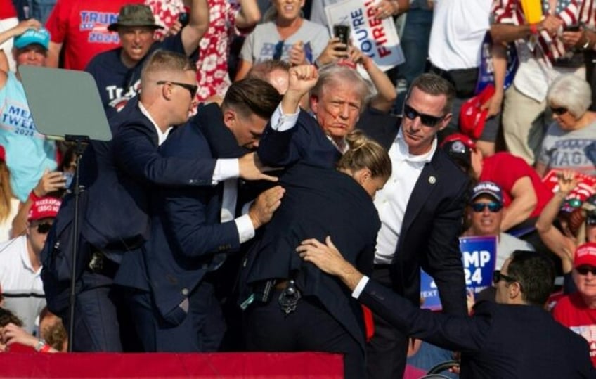 Republican presidential candidate Donald Trump surrounded by Secret Service agents after a