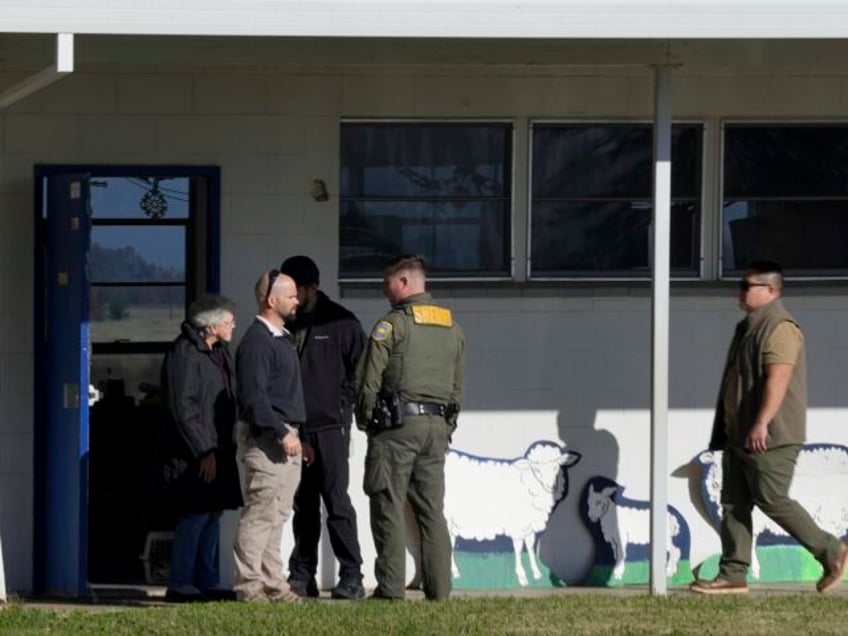 School officials and Sheriff's deputies gather outside Feather River Adventist School