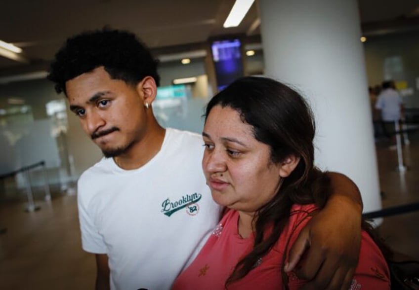 Emerson Colindres hugs his mother Ada Bell Baquedano after she returned to Honduras from t