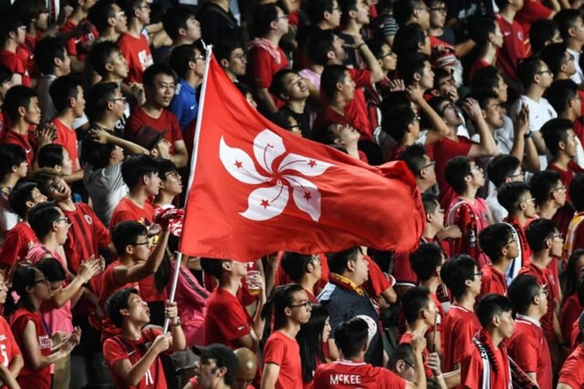 In this picture taken in 2017, Hong Kong fans hold their flag during a match