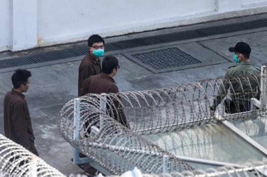 Joshua Wong (C), pictured here in 2020, became a household name during student-led protest