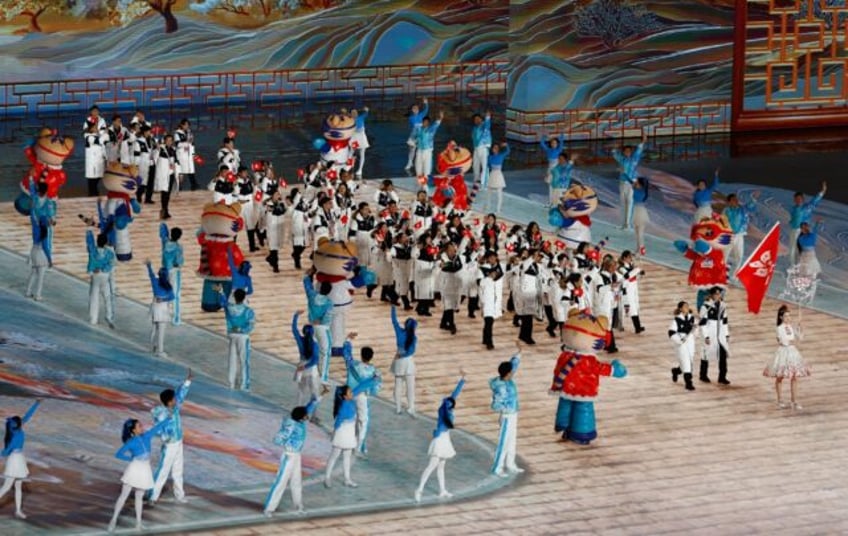 Hong Kong's flag bearers lead their contingent at the opening ceremony